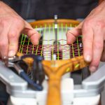 Proces naciągania historycznej lub retro rakiety tenisowej w sklepie tenisowym, koncepcja sportu i rekreacji