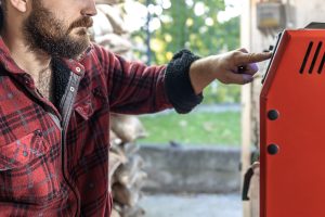 Człowiek z kotłem na paliwo stałe pracujące na biopaliwa oszczędne ogrzewanie