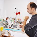 Laptop i sprzęt w fabryce browarów i myślenie z pomysłami badania i rozwoju Osoba komputer i wizja z informacjami w Internecie dla alkoholu rzemiosła piwa i narzędzia na biurku w magazynie