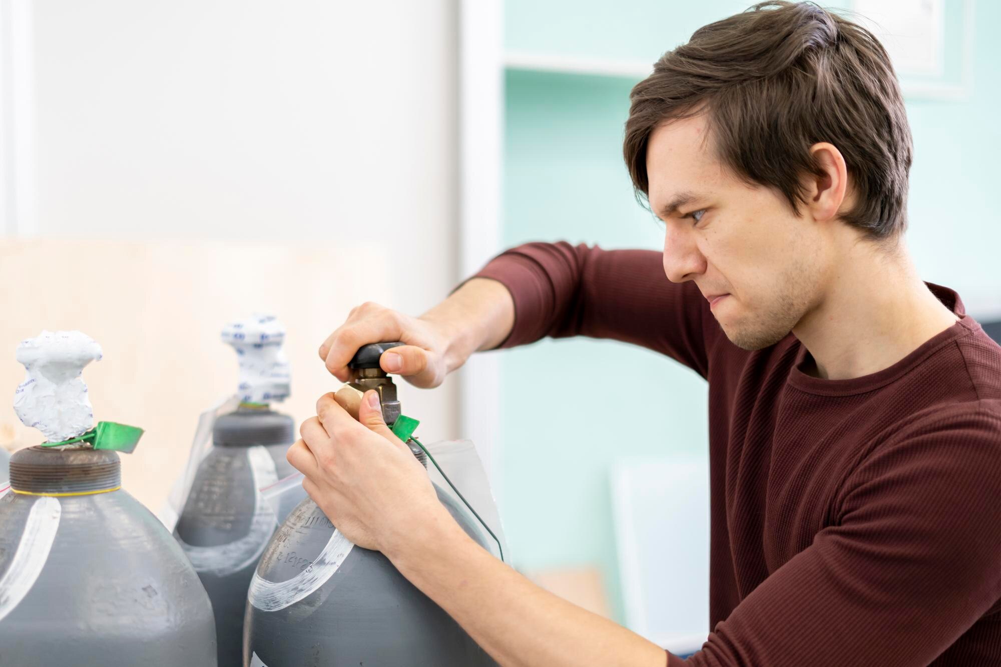 osoba otworzyć zbiornik sprężonego powietrza. butla gazowa wysokiego ciśnienia b