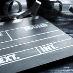 Movie clapper on wooden background closeup