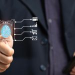 Mężczyzna skanuje swój odcisk palca, aby zweryfikować swoją tożsamość podczas transakcji biznesowej