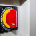 Czerwony obrotowy przycisk zasilania z bliska w fabryce