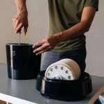 Cropped shot of technician disassembling and performing maintenance on modern black air humidifier