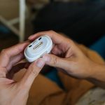 Closeup of male hands using electric nail clipper streamlining nail trimming and shaping process