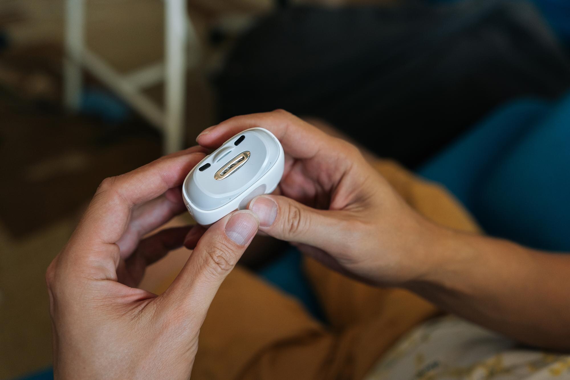 Closeup of male hands using electric nail clipper streamlining nail trimming and shaping process