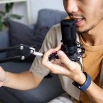 Close Up Of Young Male Speaking Into Professional Microphone During Recording Session