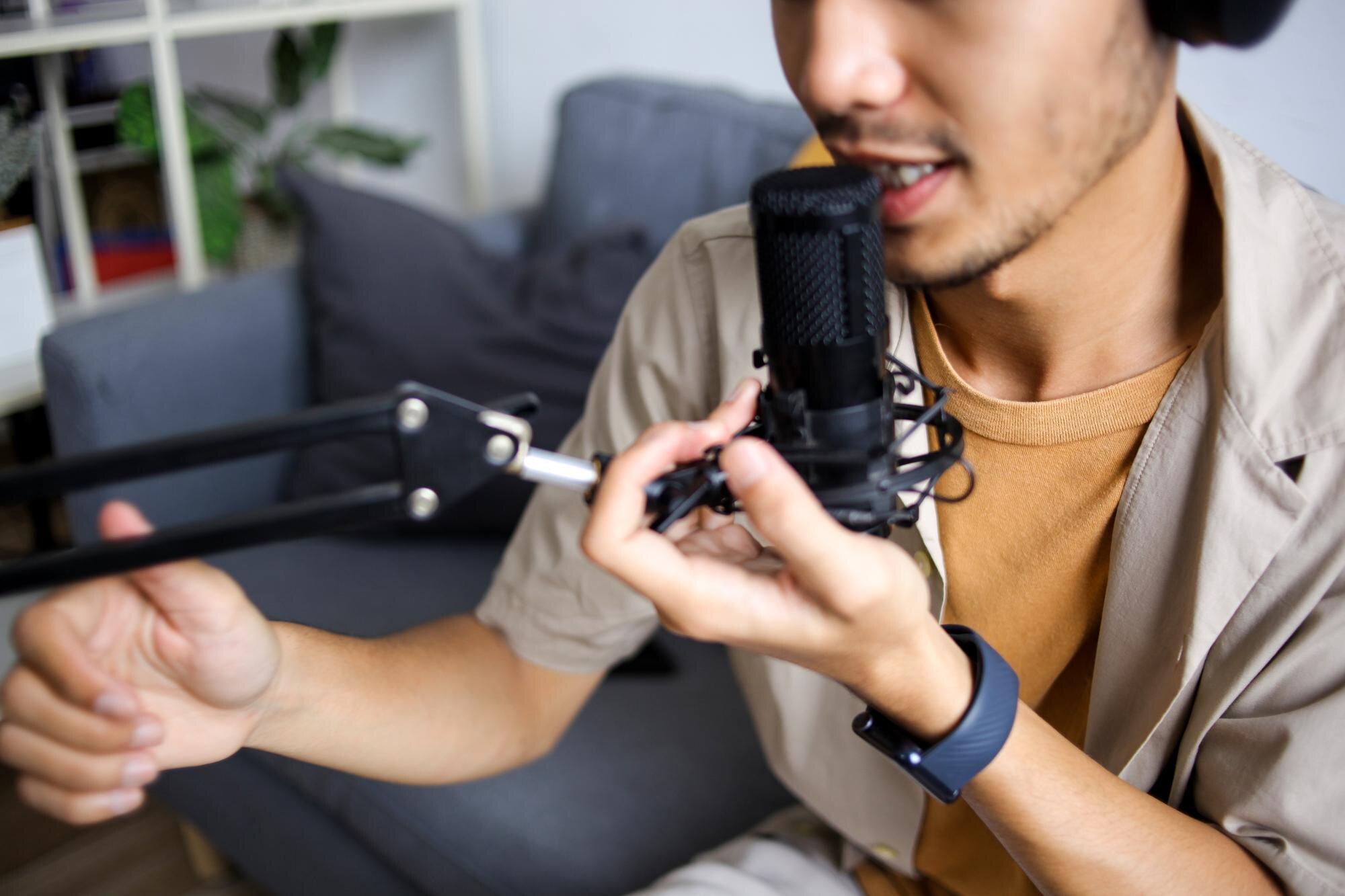 Close Up Of Young Male Speaking Into Professional Microphone During Recording Session