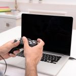 Young man playing computer games at home