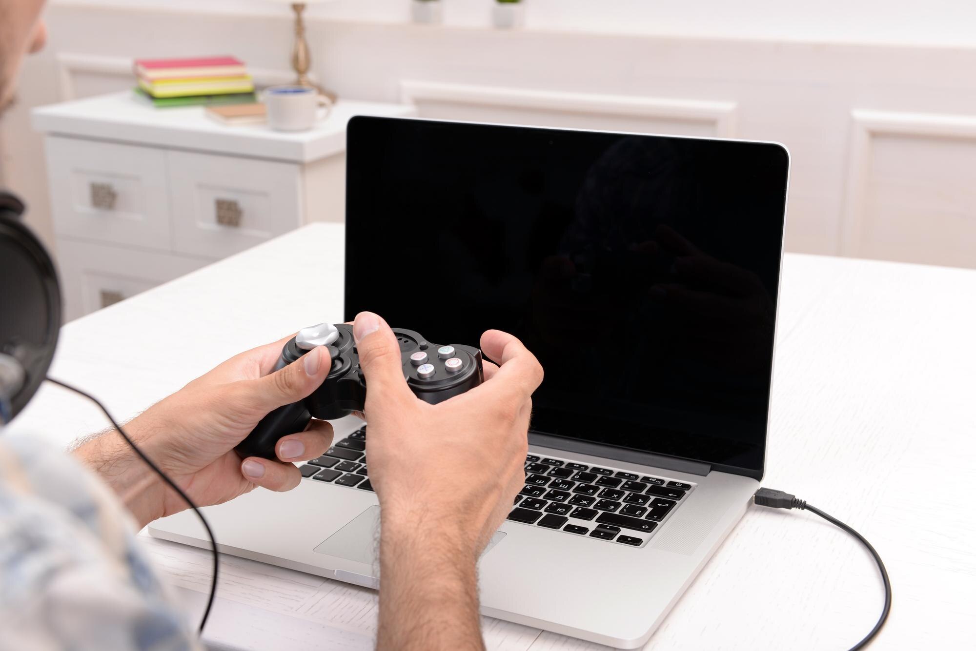 Young man playing computer games at home