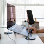 Modern Home Office Setup with Laptop Tablet and Smartphone on a White Desk