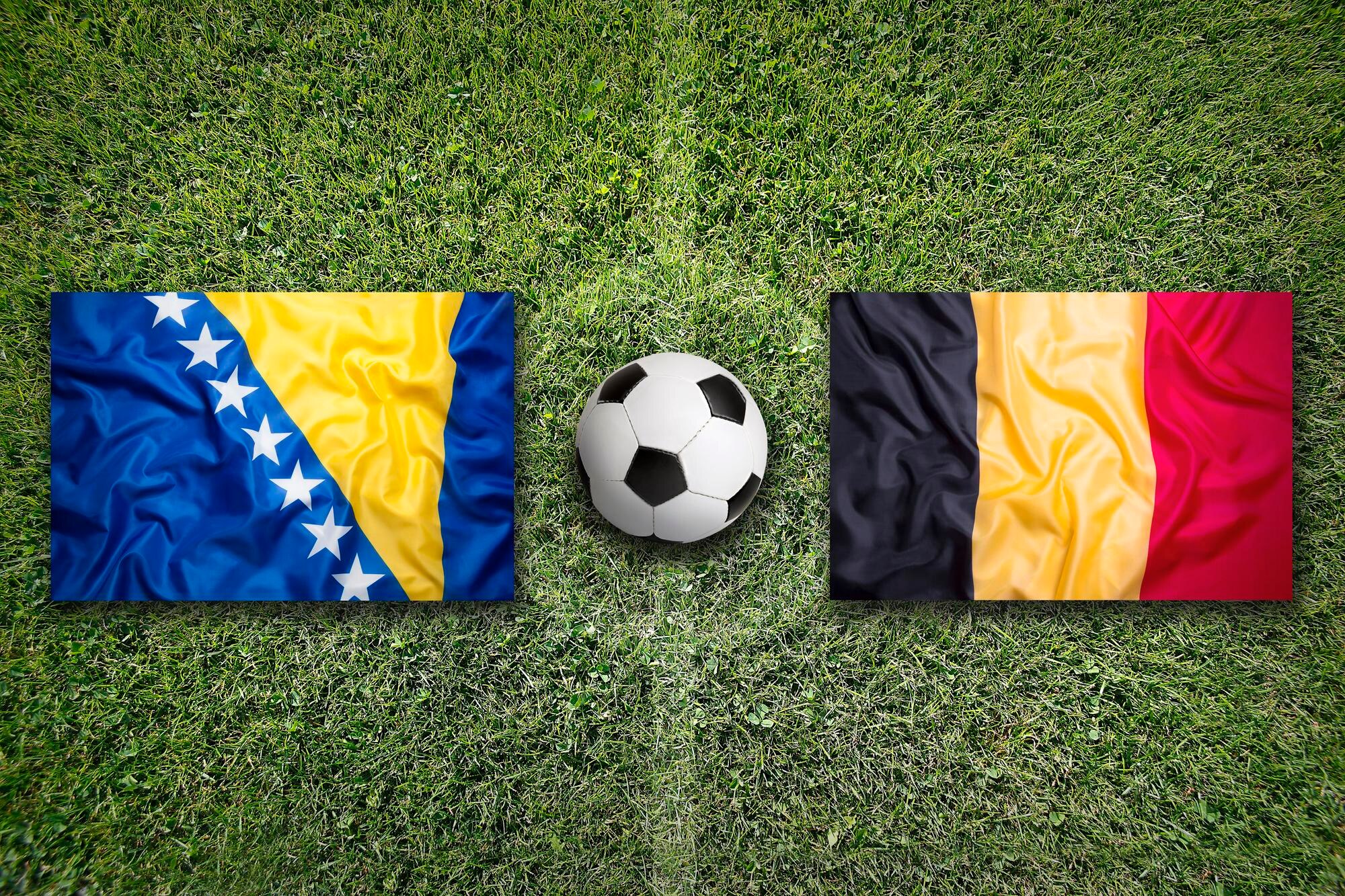 Bosnia and Herzegovina vs Belgium flags on soccer field