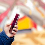 Ręce młody człowiek telefon do wyszukiwania edukacji w Internecie.