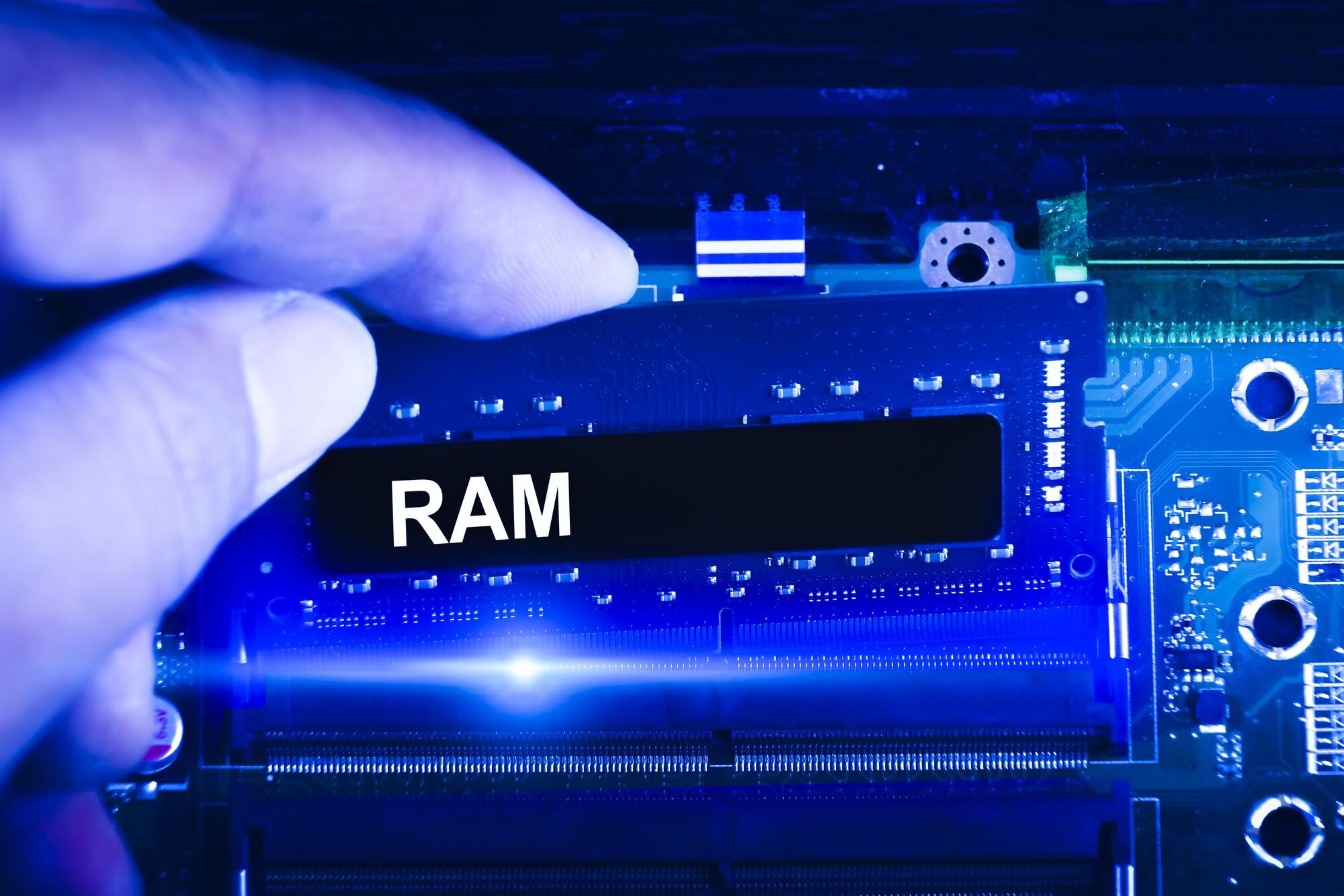 Technik ręcznie wkłada pamięć RAM do gniazda pamięci na płycie głównej komputera Technik uaktualnia pamięć RAM do niebieskiego odcienia laptopa Koncepcja technologii komputerowej